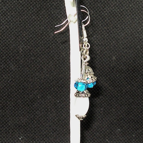 Earring with blue and white on a black background