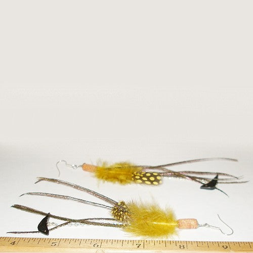 Feather earrings with yellow and brown details on a white background, with a ruler at the bottom for scale.