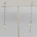 Pair of pearl earrings on a white background