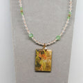 Necklace with a rectangular pendant featuring a floral design on a gray background