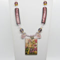 Necklace with fairy pendant and decorative beads on a white background