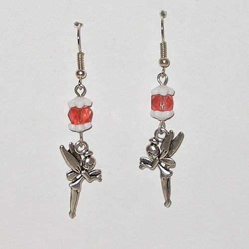 Pair of earrings with fairy charms and red beads on a white background