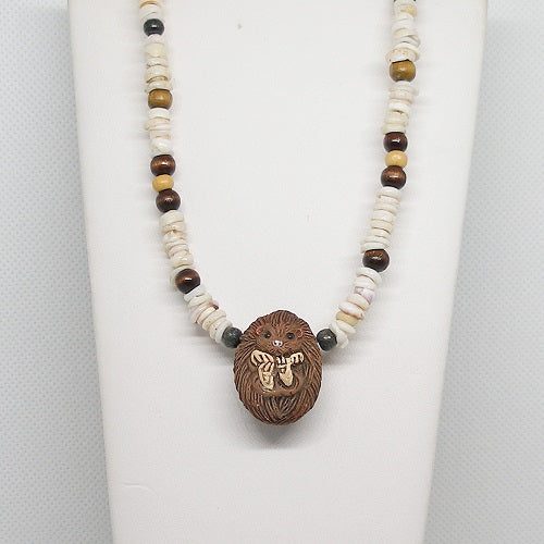 Necklace with a clay hedgehog pendant on a white background
