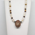 Necklace with a clay hedgehog pendant on a white background