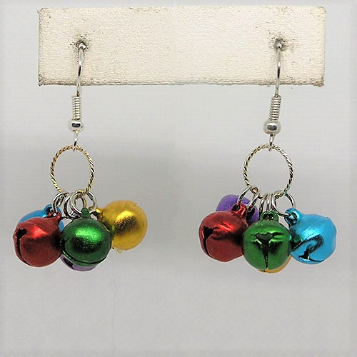 Colorful jingle bell earrings on a white card