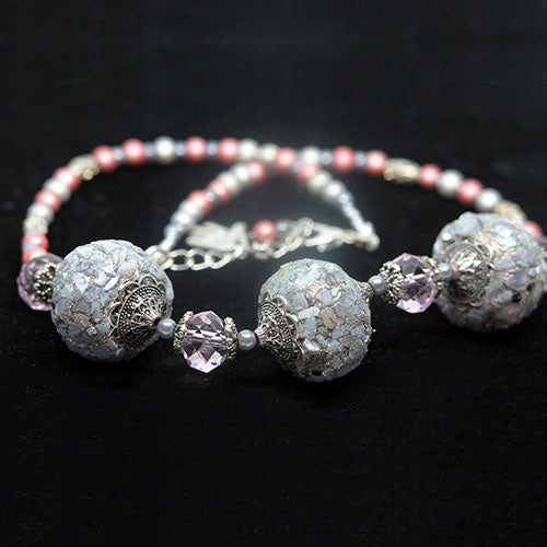 Necklace with decorative beads on a black background