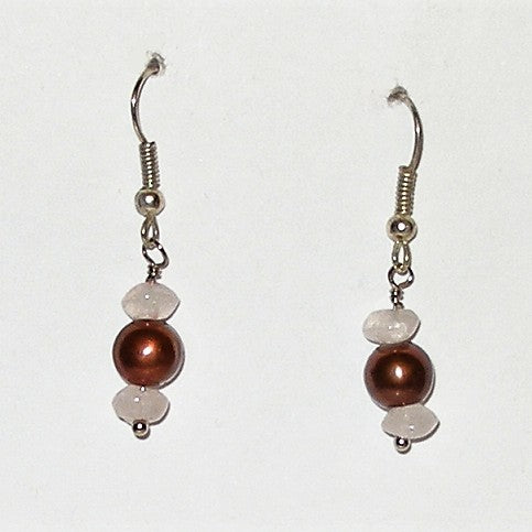 Pair of earrings with brown and pink beads on a white background