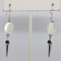 Pair of earrings with mother of pearl, amethyst and silver accents on a white background