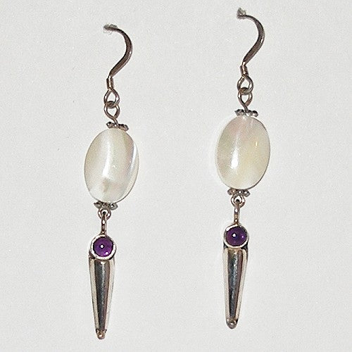 Pair of earrings with mother of pearl and purple gemstones on a white background