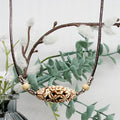 Necklace with decorative bead against a natural background