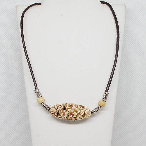 Necklace with decorative pendant on a white background