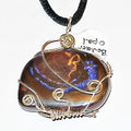 Necklace with a large, multicolored stone pendant on a white background