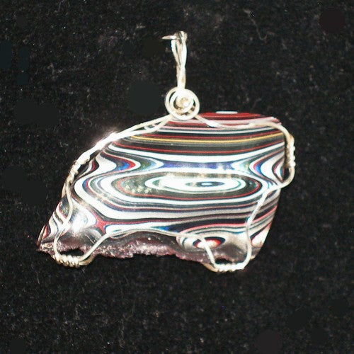 Multicolored stone pendant on a black background