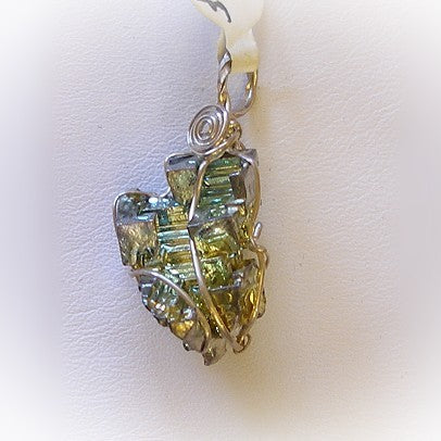 Iridescent stone pendant on a white background