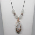 Necklace with a wire-wrapped pendant and beads on a white background