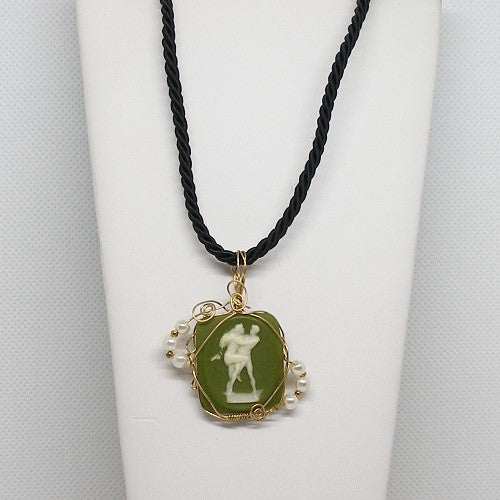 Necklace with a green pendant featuring a classical design on a white background