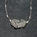 Necklace with a rainbow obsidian pendant on a dark background