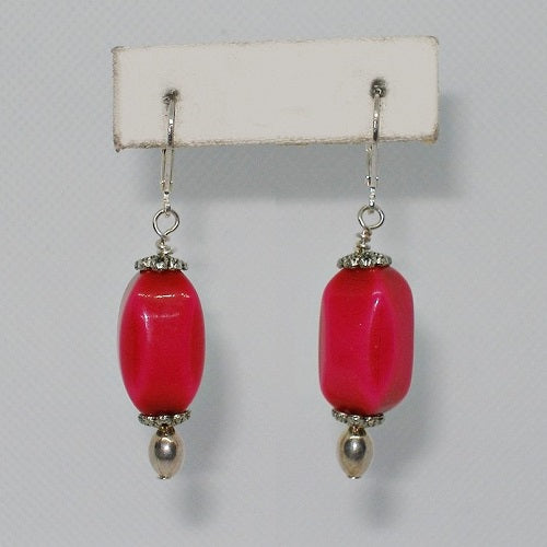 Pair of pink beaded earrings on a white background