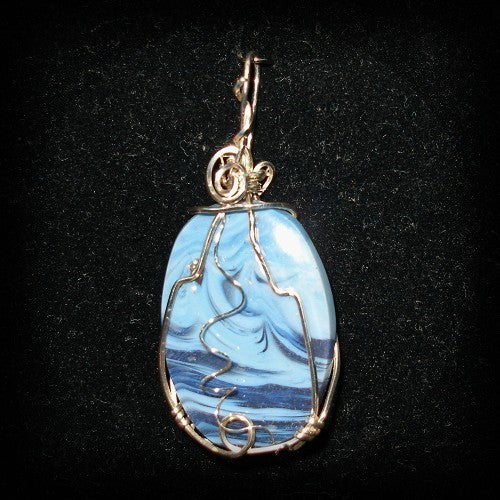 Blue marbled pendant with silver wire wrapping on a black background