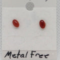 Pair of red oval earrings on a white card with 'Metal Free' text.