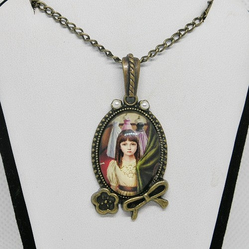 Pendant necklace with a decorative design on a white background