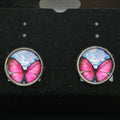 Butterfly-themed earrings on a black card