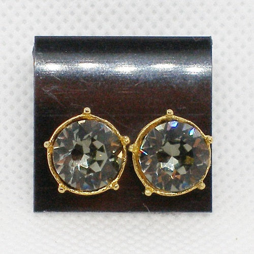 Pair of gold-framed crystal earrings on a black display card.