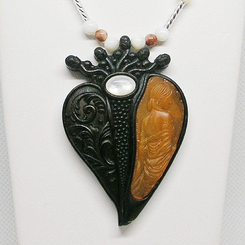 Heart-shaped pendant with black and brown design on a white background