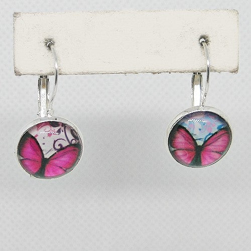 Butterfly-themed earrings on a white card with a gray background