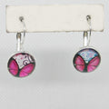 Butterfly-themed earrings on a white card with a gray background
