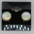 Pair of earrings with iridescent fish scale design on a black card.