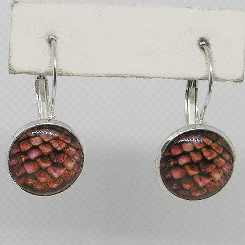 Pair of earrings with round scale design on a white card