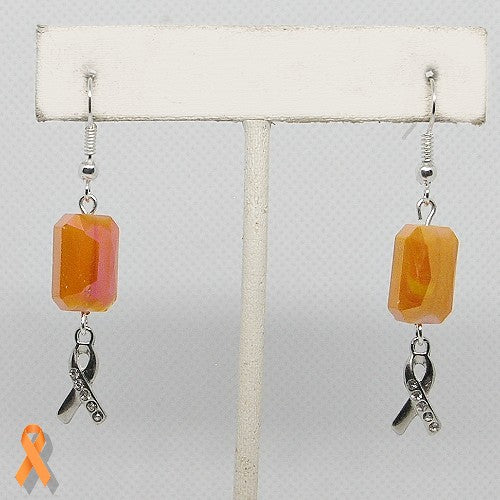 Earrings with orange beads and silver ribbons on a gray background