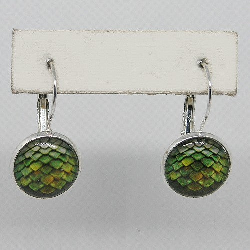 Pair of earrings with green and gold pattern on a white card