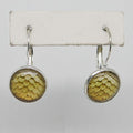 Round earrings with a textured yellow design on a white background