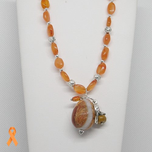 Necklace with orange beads and a large central bead on a white background