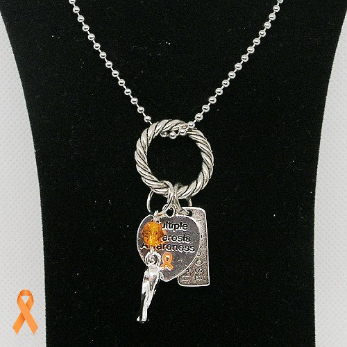 Necklace featuring silver color charms and an orange ribbon on a black stand.