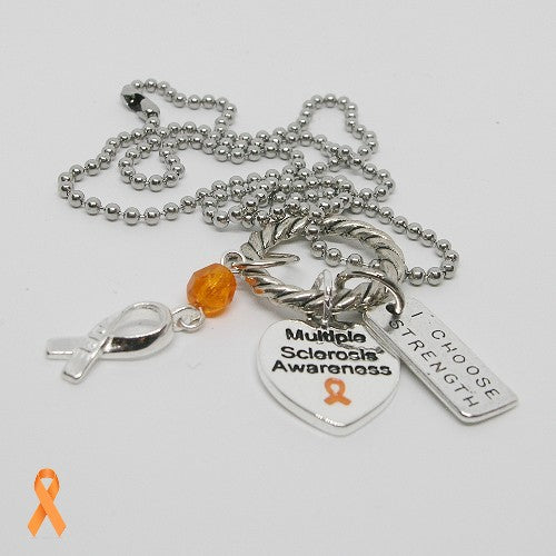 Silver necklace with multiple sclerosis awareness charms on a white background
