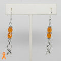 Earrings with orange beads and 'HOPE' charms on a white background