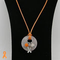 Necklace with a pendant featuring a ribbon charm on a black stand.