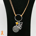Necklace with pendant on a black stand, featuring an orange ribbon symbol.