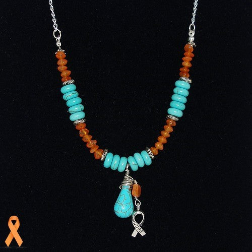 Necklace with turquoise and orange beads on a black background