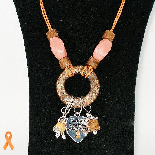 Necklace with a circular pendant and charms on a black background