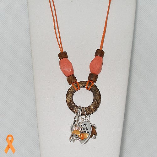 Necklace with circular pendant and heart-shaped charm on a white background