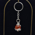 Keychain with red agate stone and silver dragon charm on a black background