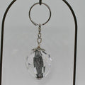 Crystal keychain with metal core on a gray background