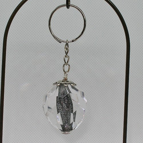 Crystal keychain with metal core on a gray background