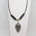 Necklace with skull pendant on a white stand