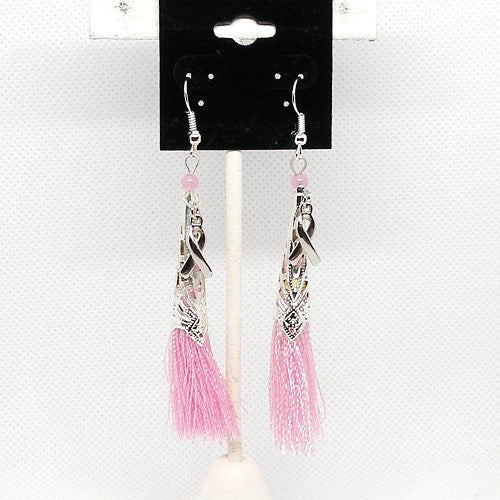 Pink tassel earrings on a display card against a white background