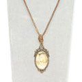Necklace with a pendant featuring a tan stone on a white background